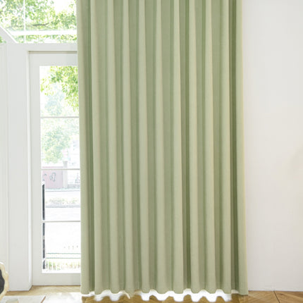a room with a window and a green curtain