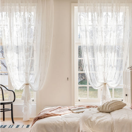 a bedroom with a bed and two windows