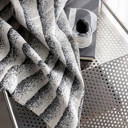 a black and white towel sitting on top of a table