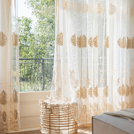 a bed sitting under a window next to a window sill