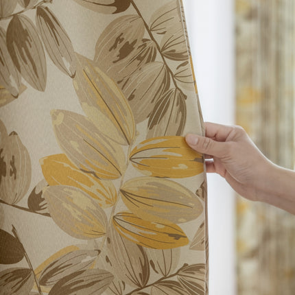 a person holding a piece of fabric with a flower pattern on it