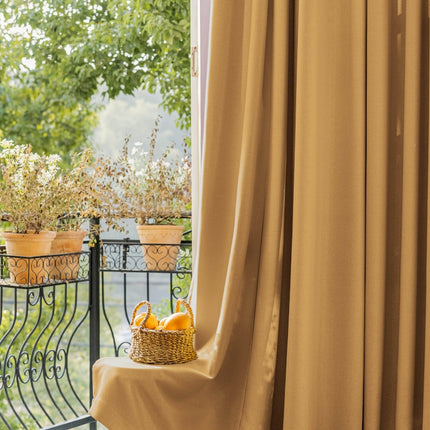 a basket of oranges sitting on top of a window sill