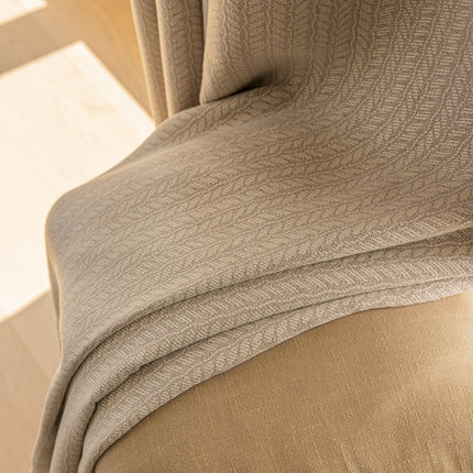 a close up of a bed with a comforter on top of it