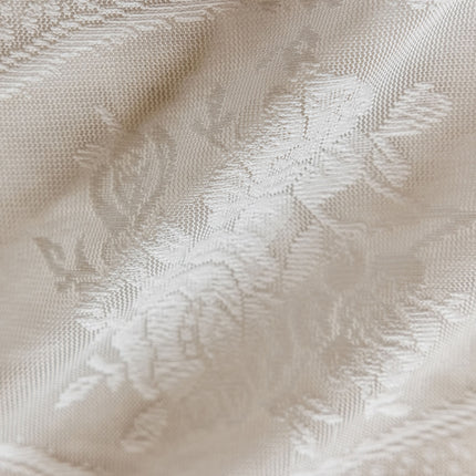 a close up of a white fabric with a pattern