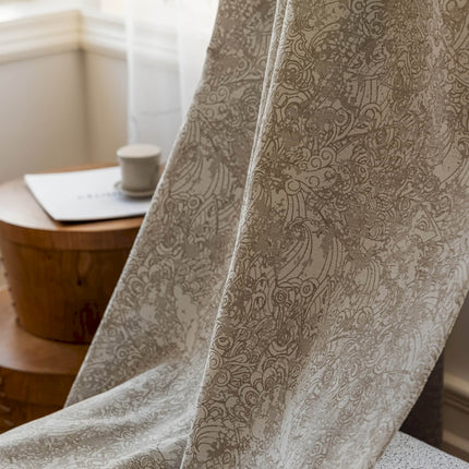 a close up of a chair with a blanket on it