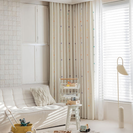 a living room with a white couch and white curtains