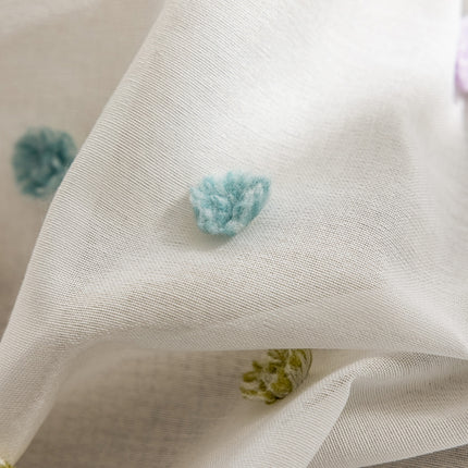 a close up of a white fabric with blue flowers on it