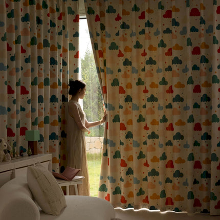 a woman standing in front of a window with a curtain