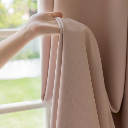 a person's hand holding a curtain in front of a window
