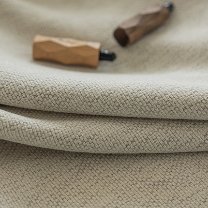 a close up of a cloth with a wooden object on it