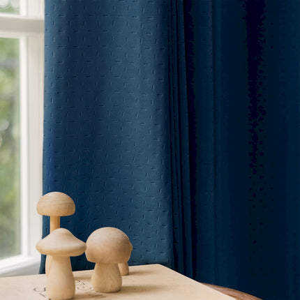 two mushrooms on a table in front of a window