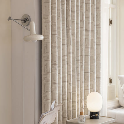 a room with a lamp and a curtain
