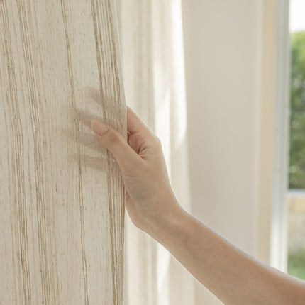 a person's hand is touching a wall with a window in the background