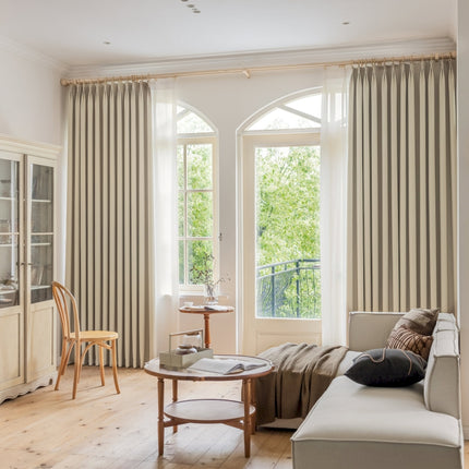 a living room filled with furniture and a large window