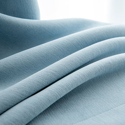 a close up of a light blue fabric
