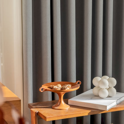 a wooden table topped with a tray of food