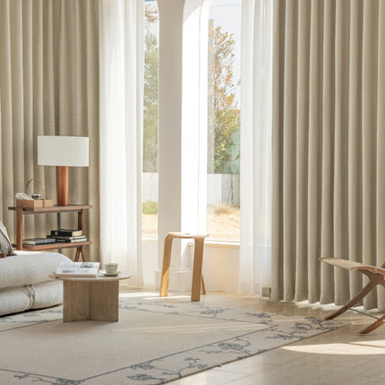a living room filled with furniture and a large window