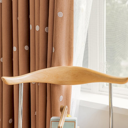 a wooden paddle sitting on top of a table next to a window