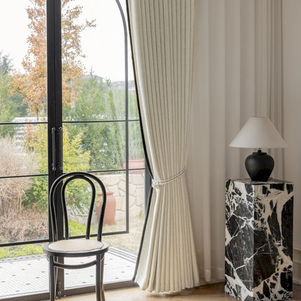 a room with a chair, table and a window