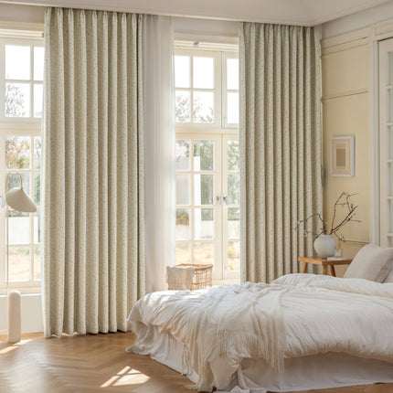 a bedroom with a large window and a white bed