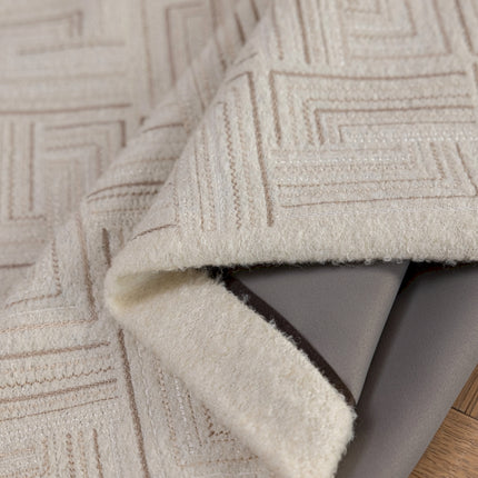 a close up of a rug on a wooden floor