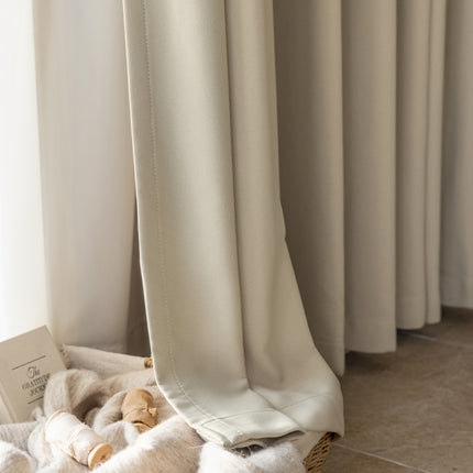 a stuffed animal laying on top of a blanket next to a window