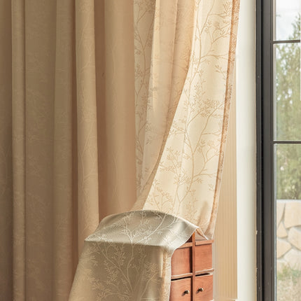a chair sitting in front of a window next to a dresser