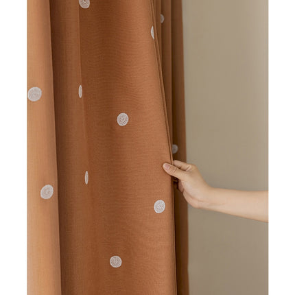 a person is opening the curtain with their hand