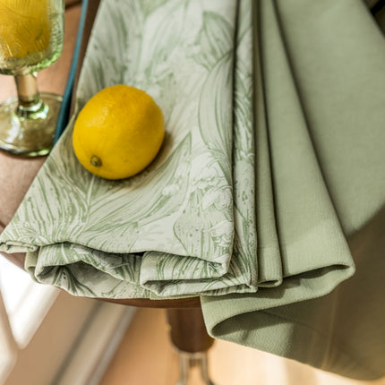 a lemon sitting on top of a table next to a glass