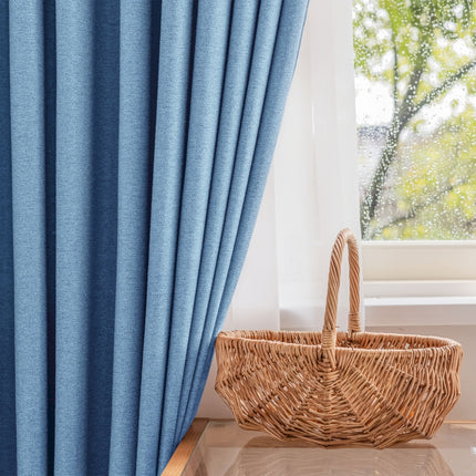 a wicker basket sitting next to a window