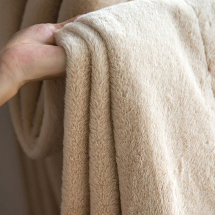 a person's hand is holding a beige towel
