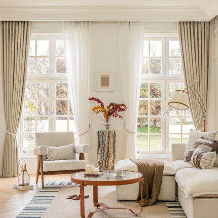 a living room filled with furniture and large windows