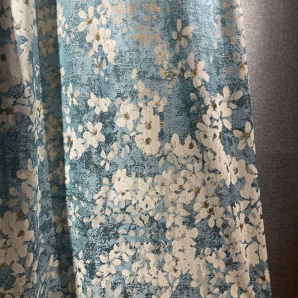 a close up of a curtain with flowers on it