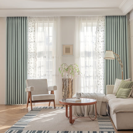 a living room filled with furniture and curtains