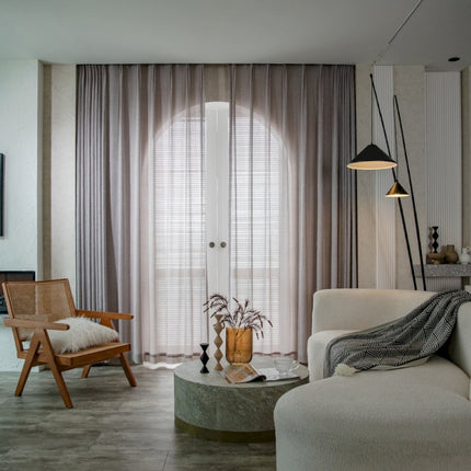 a living room filled with furniture and a large window