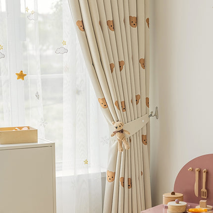 a child's room with a teddy bear curtain