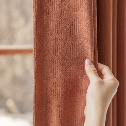 a hand is holding a curtain open to a window