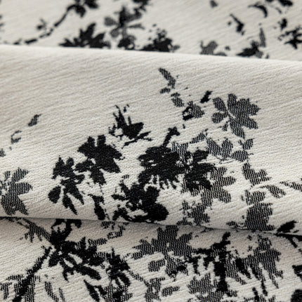 a close up of a black and white flowered fabric