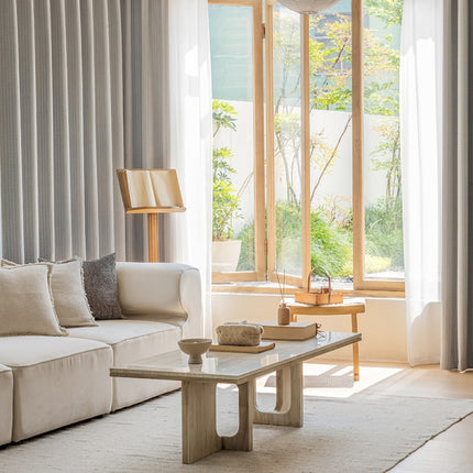 a living room filled with furniture and a large window
