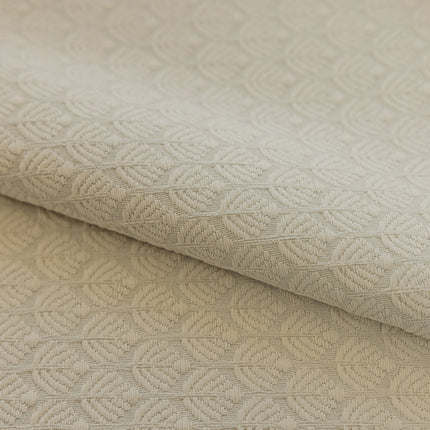 a close up of a white fabric with a pattern