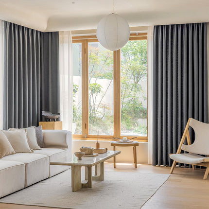 a living room filled with furniture and a large window