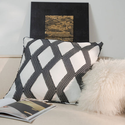a white couch with a black and white pillow