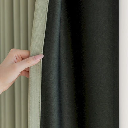 a hand is holding the curtain to the side of a window
