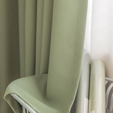 a green chair sitting next to a window