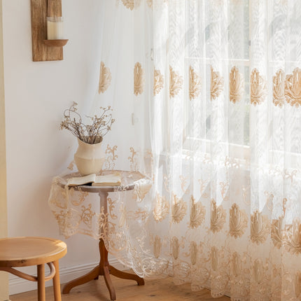 a table with a vase on top of it next to a window
